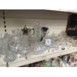 A large collection of glassware including claret jug, vases, bowls and clock etc