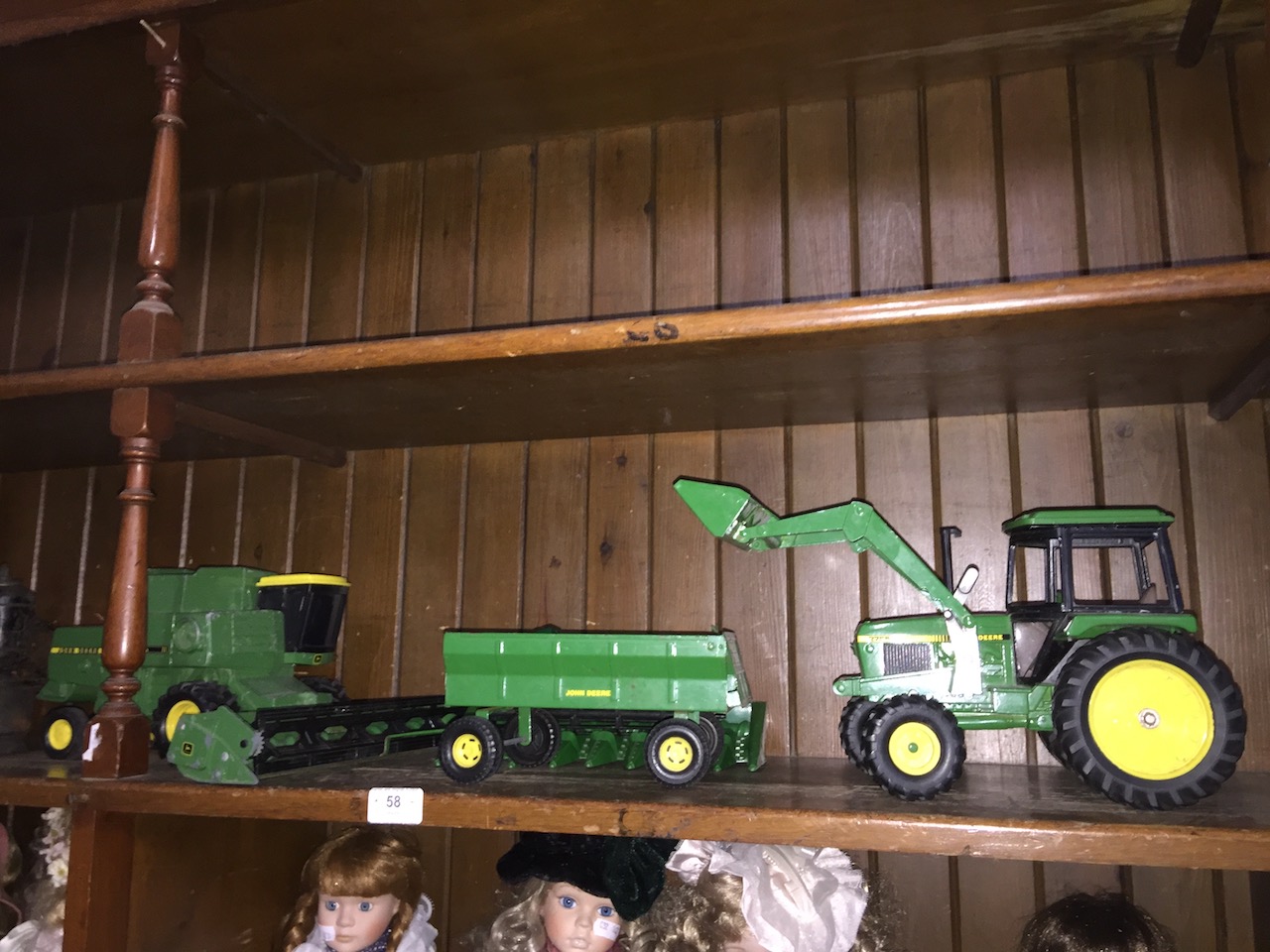 A John Deere combine harvester and tractor with trailer.