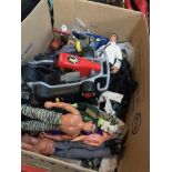 A large box with Action men, Batman figures, and other figures and clothing and accessories.