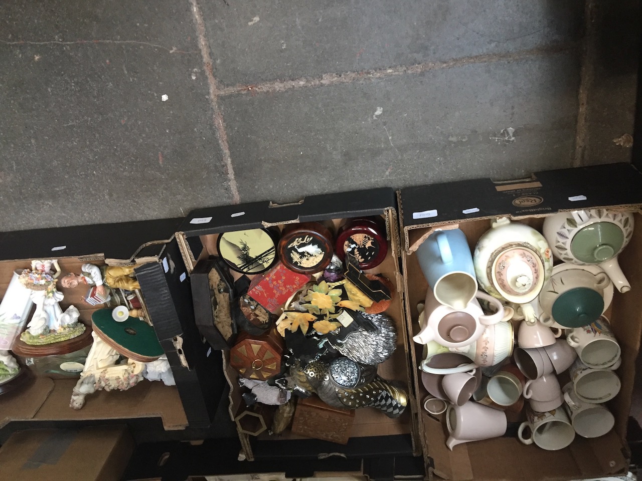 Three boxes of assorted pottery and ornaments.