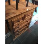 A pine chest of drawers.