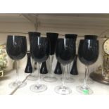 12 wine glasses with black stems or bowls