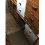 A bedroom chest of drawers with glass top and a desk with drawers and glass top.