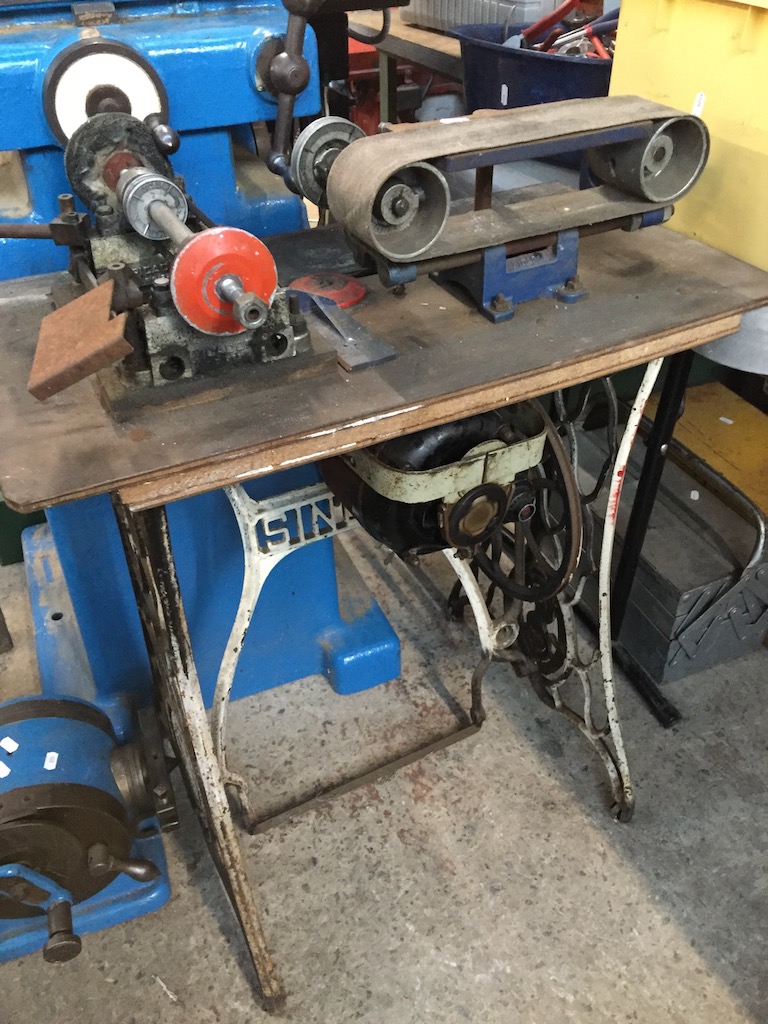 Electric custom made sander and buffer, attached on Singer sewing machine base.