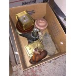 A box containing carriage clocks, animal figurines, pottery and a soapstone carved bird