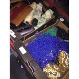 A box of purses, a handbag and a box of beads and travel umbrellas.