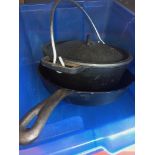 A cast metal cooking pot and a skillet