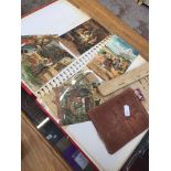 A photo album containing vintage postcards, embroidered cards etc