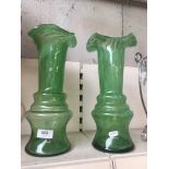 A pair of green glass vases