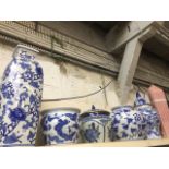Five pieces blue and white pottery including planters, ginger jar and vase