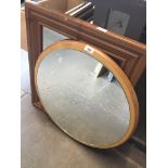 A bevelled pine framed mirror and another