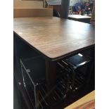 A teak extending dining table