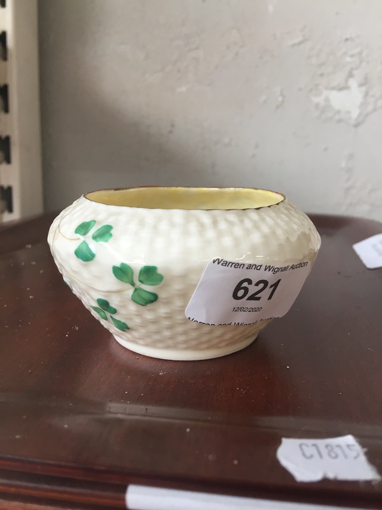 A cream Belleek small bowl decorated with shamrock style leaves