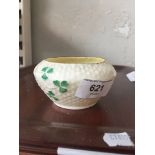 A cream Belleek small bowl decorated with shamrock style leaves