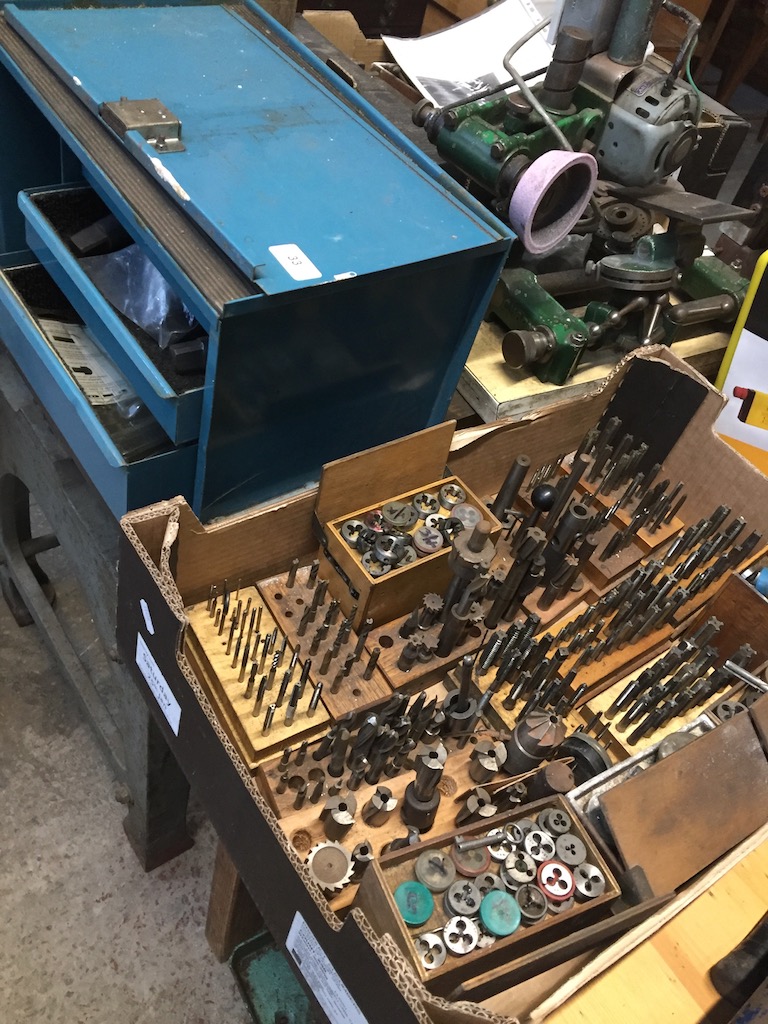 A multidrawer cabinet and a box with taps and dies and related items