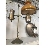 A brass lamp with glass shade