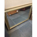 A large modern gilt framed mirror