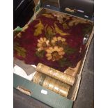 A box of misc. including a chenille table cloth, a treen dice thrower, linen, leather bound