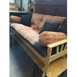 A light wood modern bed settee