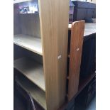 A light oak bookcase and a pine bookcase