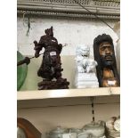 A Chinese hardwood figure, White pottery dog of foe and an ethnic carved head figure