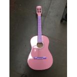 A pink Burswood acoustic guitar with soft bag.