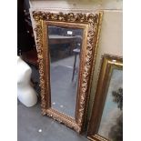 A large gilt framed mirror