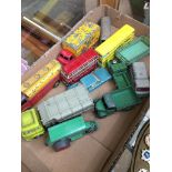 A box of play worn Dinky trucks, vans and other vehicles