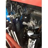 Three bags of golf clubs