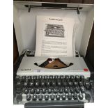 Olympia Traveller De Luxe S typewriter in original case with instructions manual.