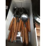 A quantity of Butler stainless steel cutlery with wooden handles.