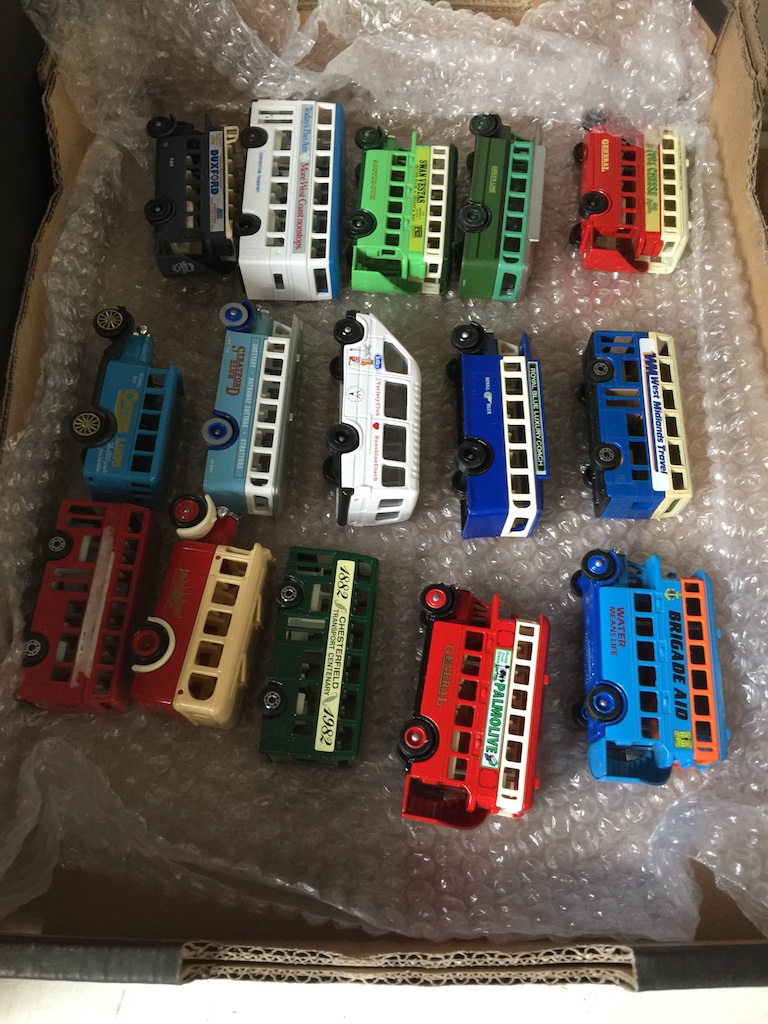 A box of model buses by Matchbox, Lledo etc