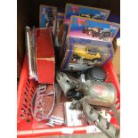 A crate with various collectables including old Daimler car badge, boxed model vehicles, Minolta