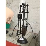 A Large metal candle holder and a fireside companion set