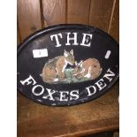 A cast metal plaque "The Foxes Den" 35cm x 26cm.