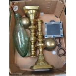 A box containing a pair of brass candlesticks, a carved Welsh spoon, an old bottle etc.