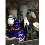 A box of stoneware, old bottles, etc.