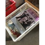 A plastic crate of pottery and glass together with Rolling Stones and The Beatles books.