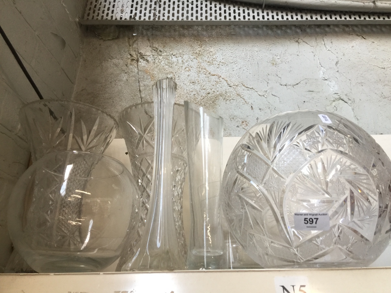 A large glass bowl, other glassware including vases