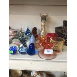 A collection of paperweights and coloured glassware