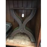 A pair of cast iron X-frame bench ends.