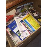 A box of football programmes and memorabilia.