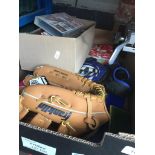 A box of sporting items, Liverpool FC football programmes, baseball glove etc