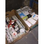 A box of electric breakers and a box of various electrical fittings.