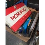 A box of board games including Monopoly, Scrabble etc