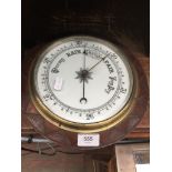 A carved oak frame barometer.