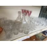 A collection of glassware including a pair of 19th century decanters and eight matching glasses