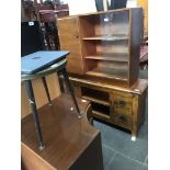 A bookcase with glass sliding doors and a corner cabinet.