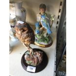 Two bird figures, including a Country Artist's Owl and Mouse figure, and a figure of a boy selling