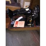 A Singer Class 99K sewing machine with accessories and manual in original case.